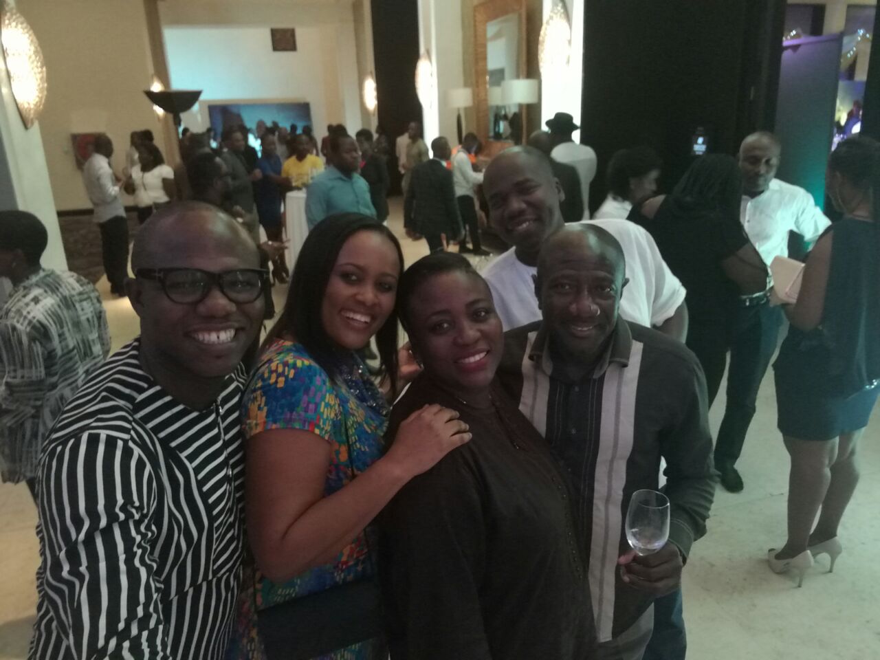 CEO of MTN Ghana, Ebenezer Asante (holding glass) in a pose with some staff and customers at the event