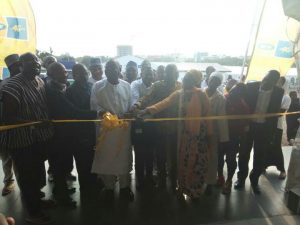 Sheikh I.C Quaye being assisted by MTN Ghana officials to cut the ribbon to open the lodging facility 