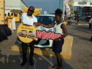From (l-r) Noel Kojo-Ganson, GM Consumer Marketing, MTN Ghana presenting the keys of the car to Ms Linda Aryee