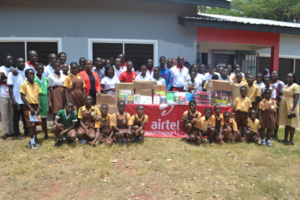 Staff from Airtel Ghana, with staff and pupils from La wireless Cluster of Schools in a pose after the donations